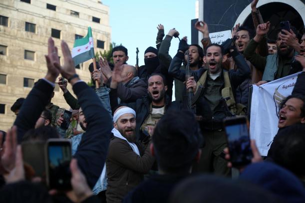 Homs (Syrian Arab Republic), 08/12/2024.- Syrian people and rebels celebrate in the streets of Homs, Syria, 08 December 2024. Syrian rebels entered Damascus on 08 December 2024 and announced in a televised statement the 'Liberation of the city of Damascus and the overthrow of Bashar al-Assad', as well as the release of all the prisoners. The rebels also urged the Syrian armed forces to leave Syrian public institutions, which will stay under the control of the outgoing Syrian prime minister until the official handover ceremony. (Siria, Damasco) EFE/EPA/BILAL ALHAMMOUD