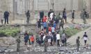 CEUTA (ESPAÑA), 31/07/2026.- Grupos de inmigrantes empiezan a volver a su país por la frontera del Tarajal en Ceuta este viernes, donde se han registrado violentos enfrentamientos en los perímetros fronterizos durante su intento de acceder desde Marruecos hacia Ceuta y Melilla. EFE/ Reduan Dris