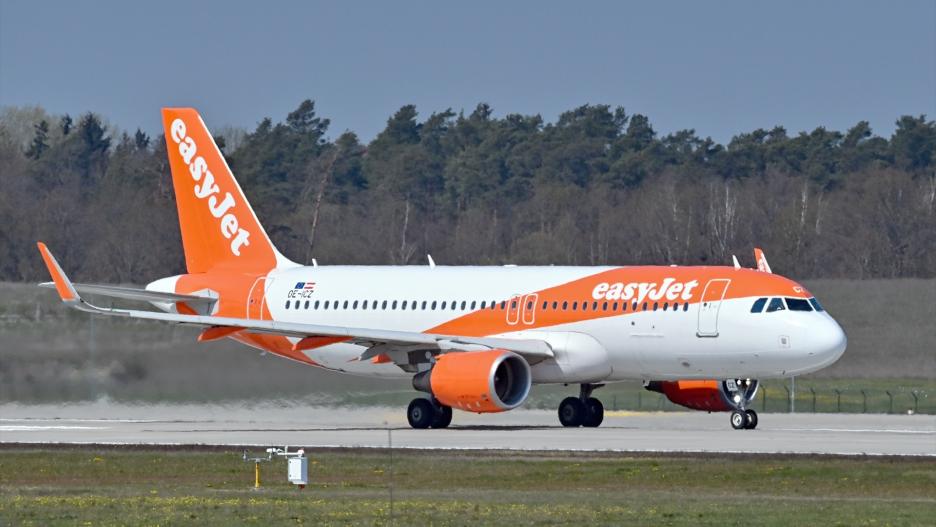 FILED - 28 April 2021, Brandenburg, Schoenefeld: A passenger plane of the British airline easyJet stands on the southern runway of the capital's airport Berlin Brandenburg BER before takeoff. EasyJet cancelled dozens of flights due to lack of staff. Photo