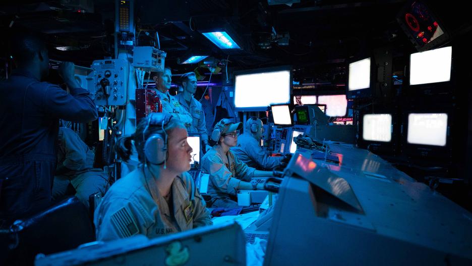 231019-N-GF955-1030 RED SEA (Oct. 19, 2023) Sailors assigned to the Arleigh Burke-class guided-missile destroyer USS Carney (DDG 64) stand watch in the ship’s Combat Information Center during an operation to defeat a combination of Houthi missiles and unmanned aerial vehicles, Oct. 19. Carney is deployed to the U.S. 5th Fleet area of operations to help ensure maritime security and stability in the Middle East region. (U.S. Navy photo by Mass Communication Specialist 2nd Class Aaron Lau)